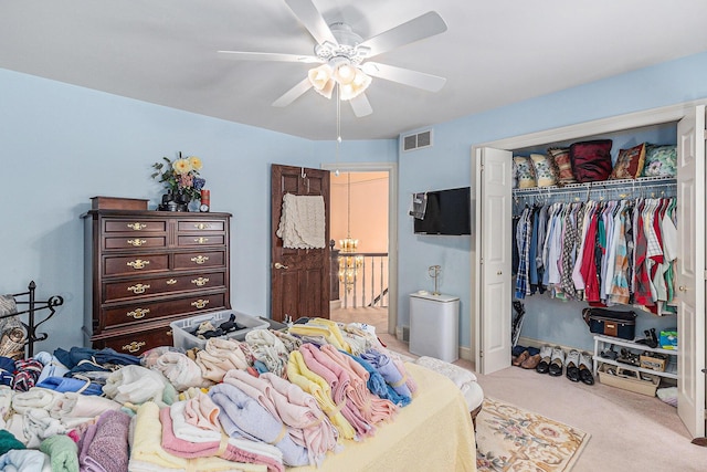 bedroom with light carpet, a closet, and ceiling fan