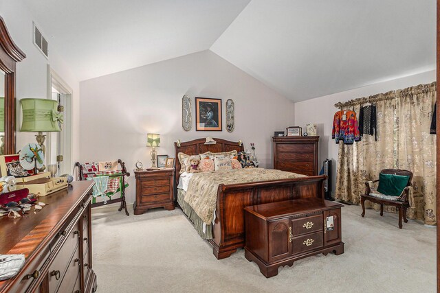 bedroom featuring light carpet and vaulted ceiling