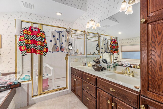 bathroom with tile patterned floors, vanity, and a shower with shower door