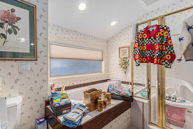 bathroom with toilet and lofted ceiling