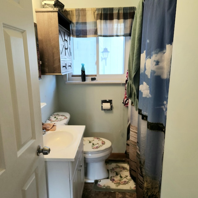 bathroom featuring vanity and toilet