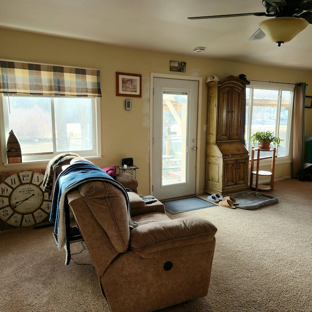 carpeted living room with ceiling fan