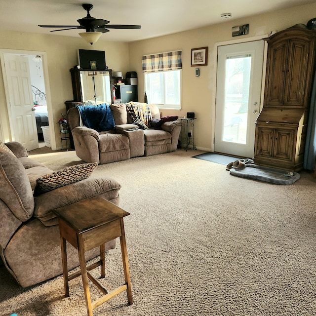 carpeted living room featuring ceiling fan