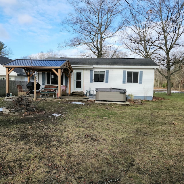 view of front facade with a front yard and a hot tub