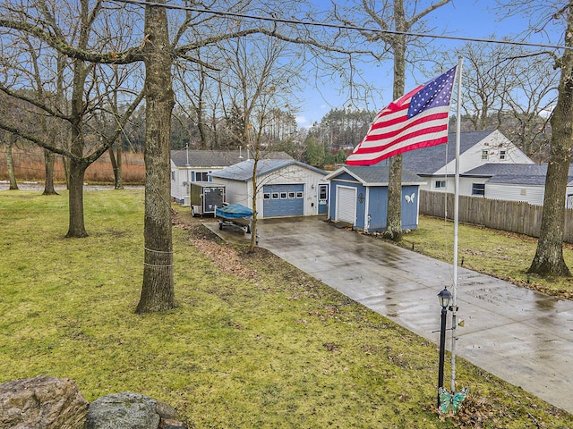 exterior space featuring an outdoor structure, a front yard, and a garage