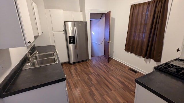 kitchen with stainless steel fridge, dark hardwood / wood-style floors, white cabinetry, and sink