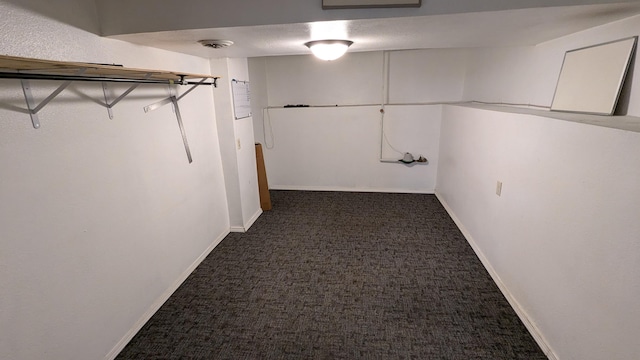 interior space with dark colored carpet