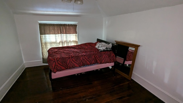 bedroom with dark wood-type flooring