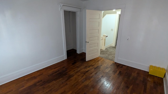 unfurnished room featuring dark hardwood / wood-style flooring