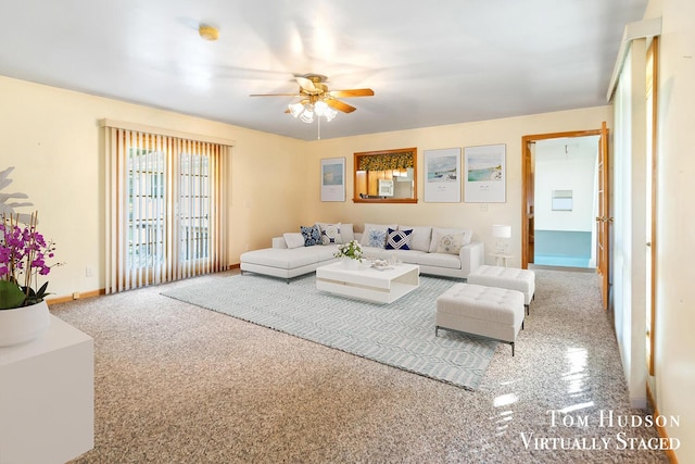 living room with light carpet and ceiling fan