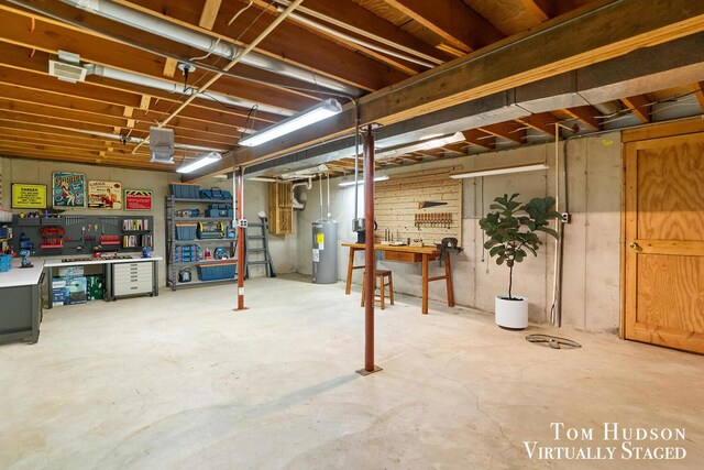 basement featuring a workshop area and electric water heater