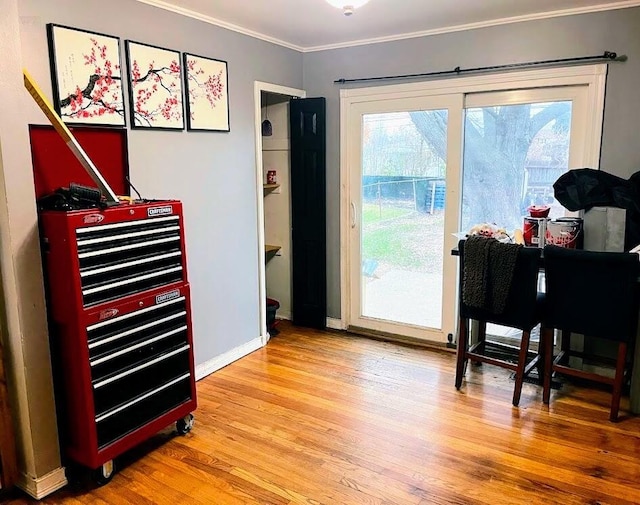 entryway featuring crown molding and hardwood / wood-style floors