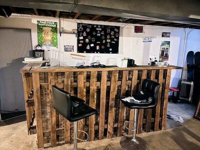 bar with radiator heating unit and concrete flooring