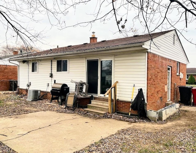 rear view of property featuring cooling unit and a patio