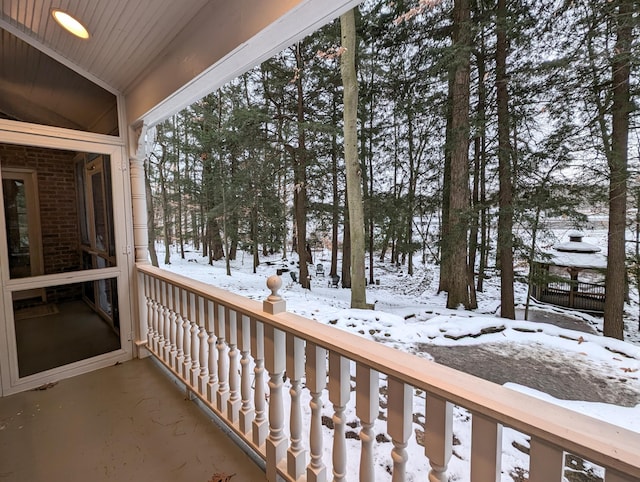 view of snow covered back of property