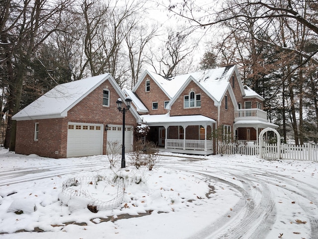 view of front of house with a porch, a garage, and a balcony