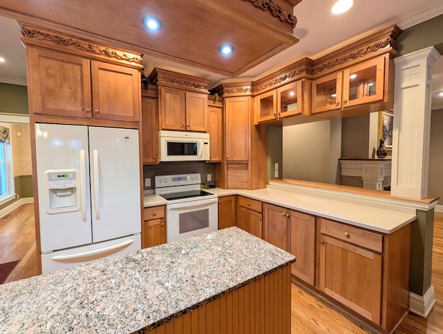 kitchen featuring kitchen peninsula, light stone counters, light hardwood / wood-style flooring, and white appliances