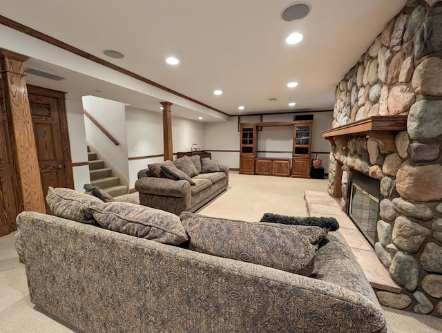 living room featuring a fireplace, light colored carpet, and crown molding