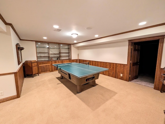 playroom featuring crown molding, light carpet, and wooden walls