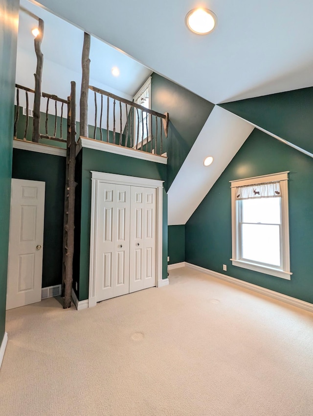 bonus room with carpet and vaulted ceiling