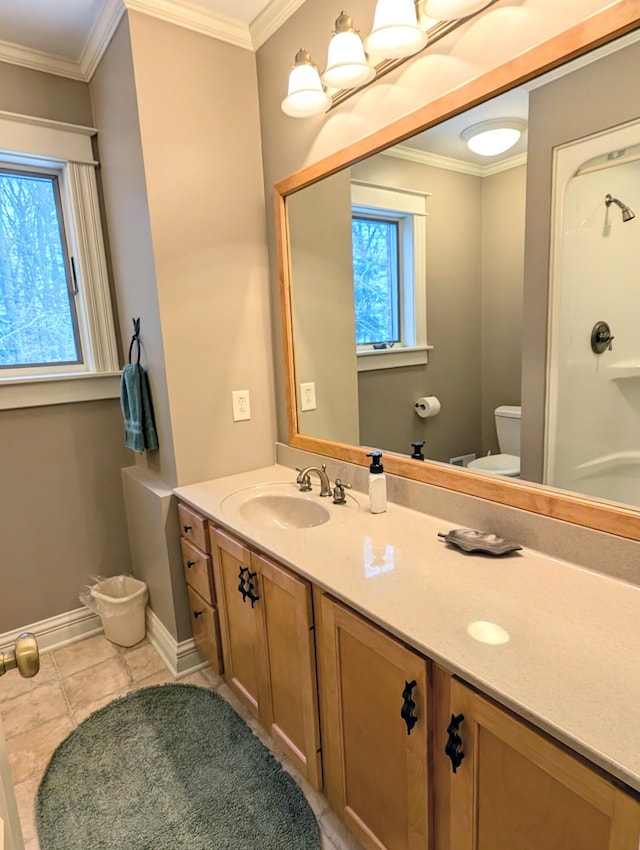 bathroom with tile patterned floors, toilet, vanity, and ornamental molding