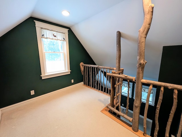 bonus room with carpet flooring and lofted ceiling