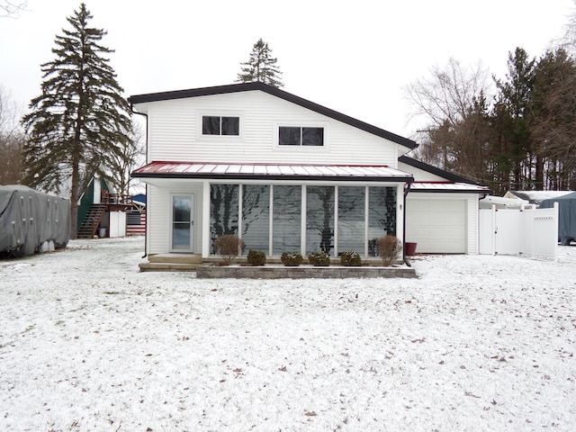 snow covered property featuring a garage