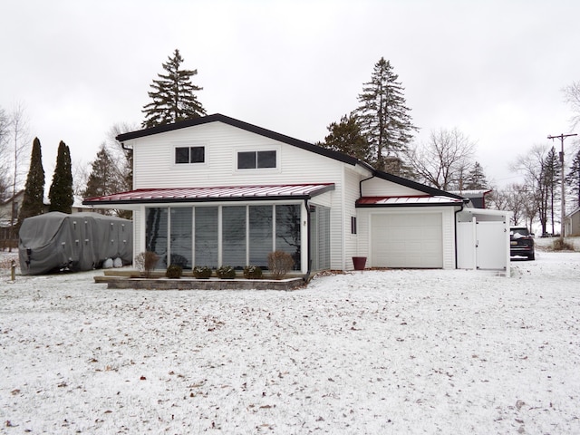 snow covered property featuring a garage