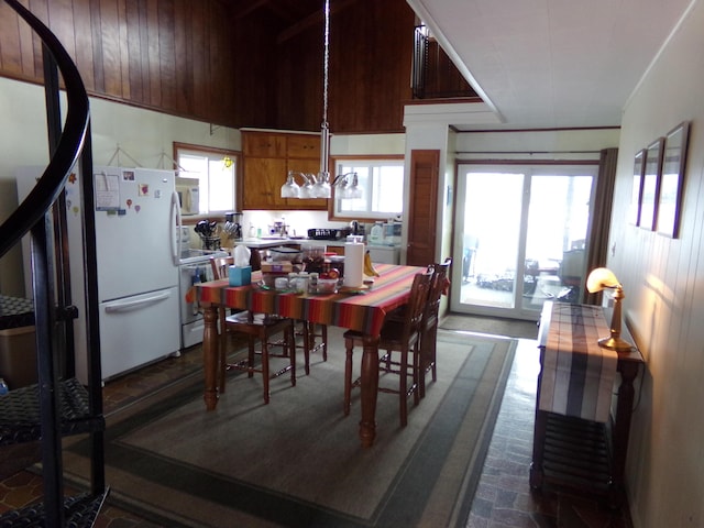 dining space featuring wooden walls