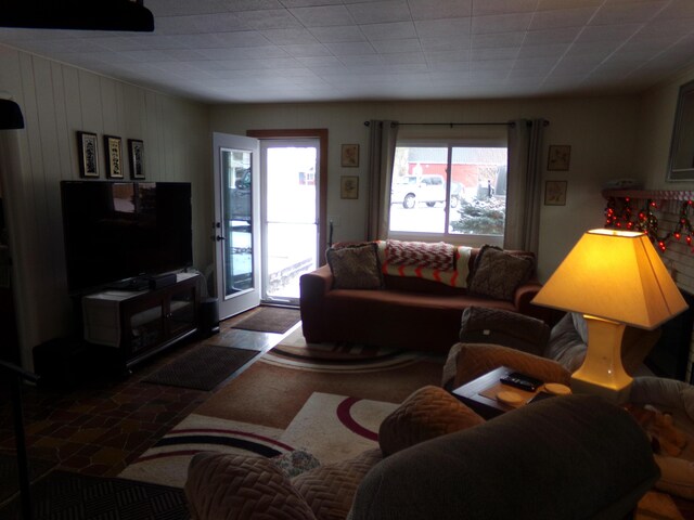 living room with wooden walls and plenty of natural light