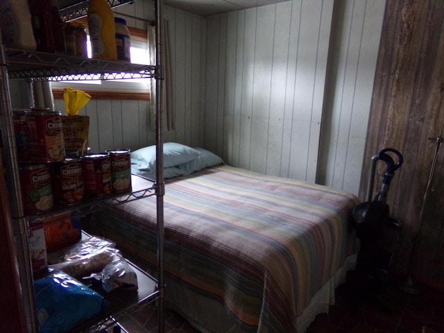 bedroom featuring wood walls