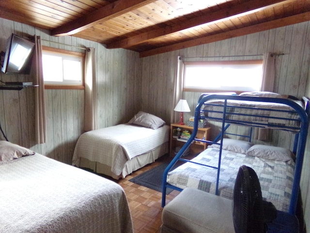 bedroom with wooden ceiling, wood walls, beamed ceiling, and parquet flooring