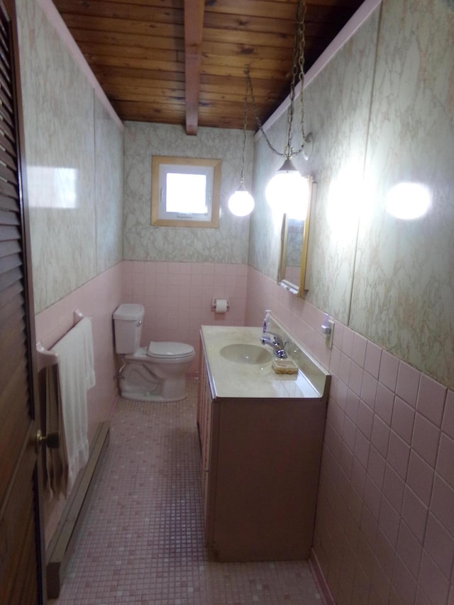 bathroom featuring tile patterned flooring, tile walls, wood ceiling, toilet, and vanity