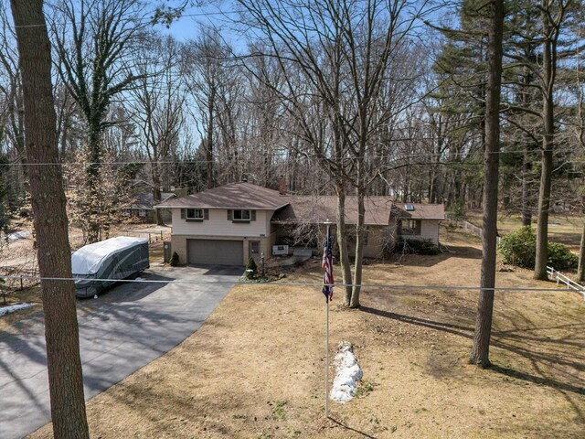 7293 M-116, Ludington, MI 49431 - tri-level home with aphalt driveway, a garage, and fence