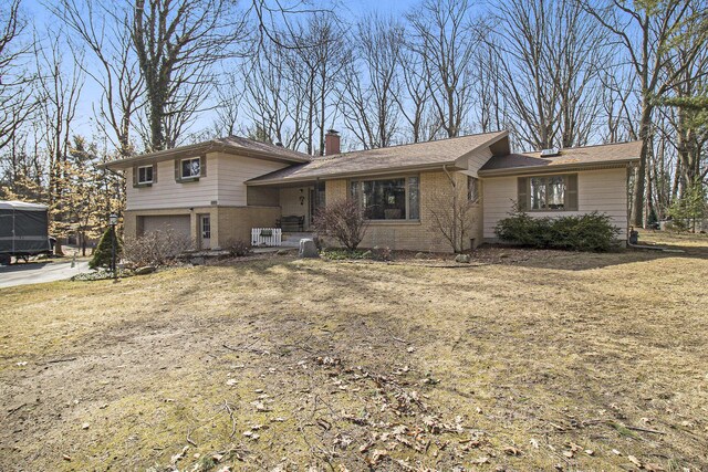 7293 M-116, Ludington, MI 49431 - split level home with a garage, brick siding, and a chimney