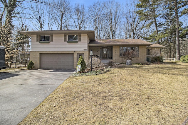 7293 M-116, Ludington, MI 49431 - tri-level home featuring a garage, brick siding, and concrete driveway