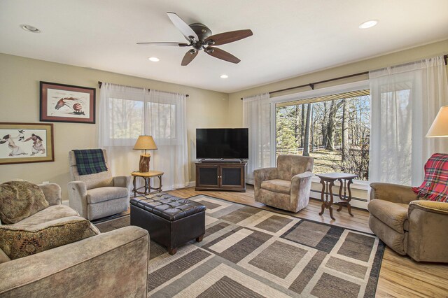 7293 M-116, Ludington, MI 49431 - living area featuring recessed lighting, a baseboard radiator, wood finished floors, and a ceiling fan