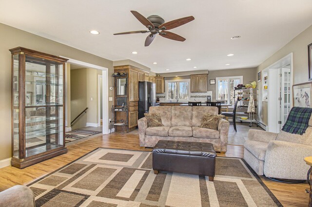 7293 M-116, Ludington, MI 49431 - living room featuring ceiling fan, baseboards, light wood-style flooring, and recessed lighting