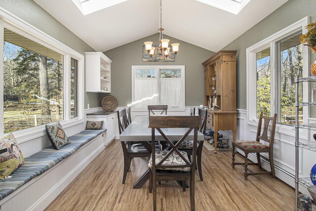 7293 M-116, Ludington, MI 49431 - dining area with a notable chandelier, plenty of natural light, and light wood-type flooring