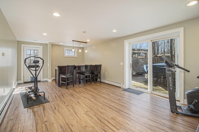 7293 M-116, Ludington, MI 49431 - workout area with a baseboard radiator, baseboard heating, a healthy amount of sunlight, and wood finished floors