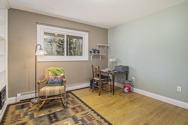 7293 M-116, Ludington, MI 49431 - office area featuring baseboards, wood-type flooring, and baseboard heating
