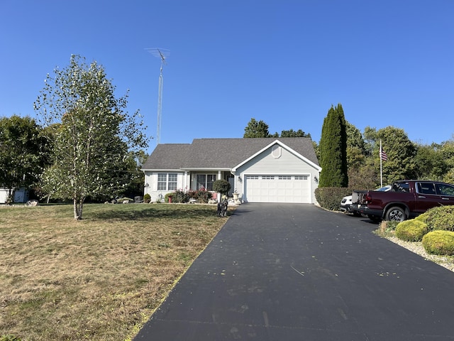 view of front of house with a garage and a front lawn