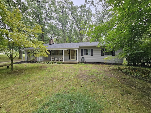 ranch-style home with covered porch and a front yard