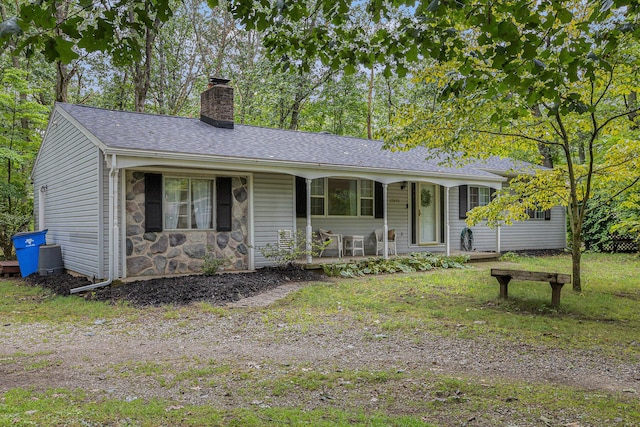 ranch-style house with a porch and a front yard