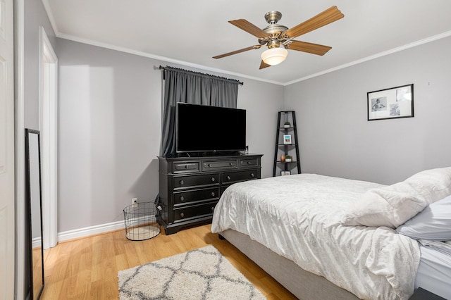 bedroom with hardwood / wood-style floors, ceiling fan, and crown molding