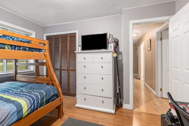 bedroom featuring light hardwood / wood-style flooring and a closet