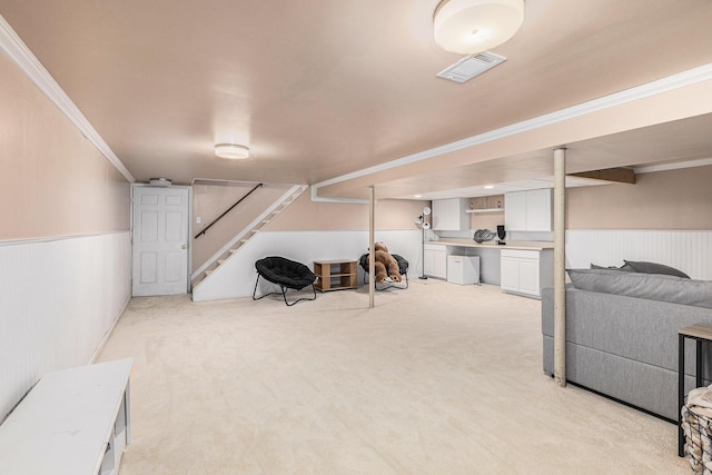 basement with ornamental molding and light carpet