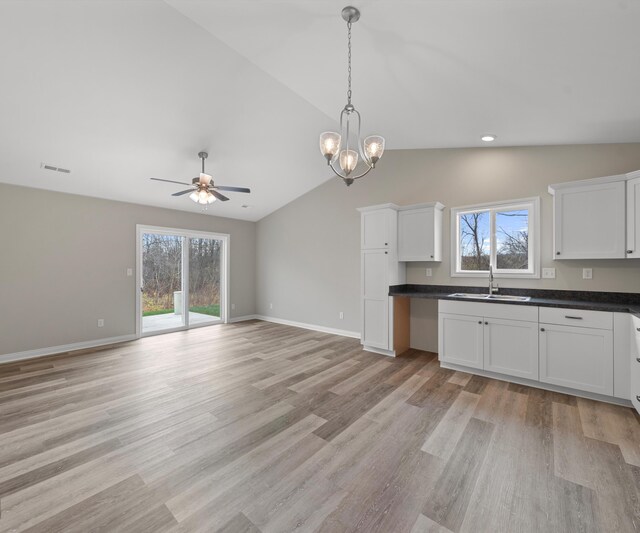 kitchen featuring lofted ceiling, a wealth of natural light, and light hardwood / wood-style flooring