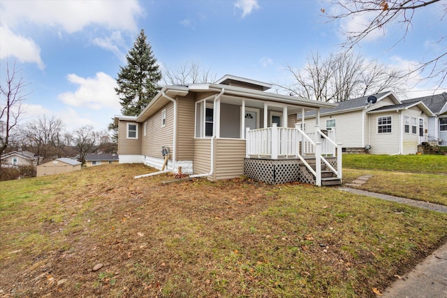 bungalow featuring a porch and a front lawn