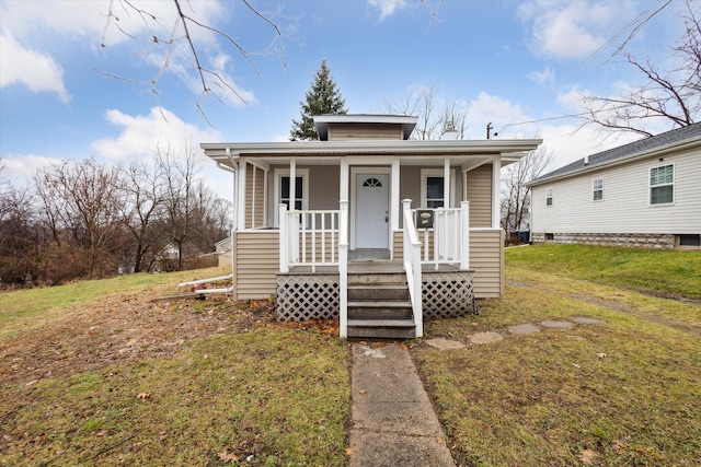 bungalow-style home featuring a front lawn